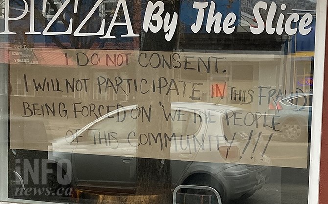 A sign in the window of Bokboks' Pizza shop in Keremeos condemned COVID-19 regulations as a 'fraud on the community.'