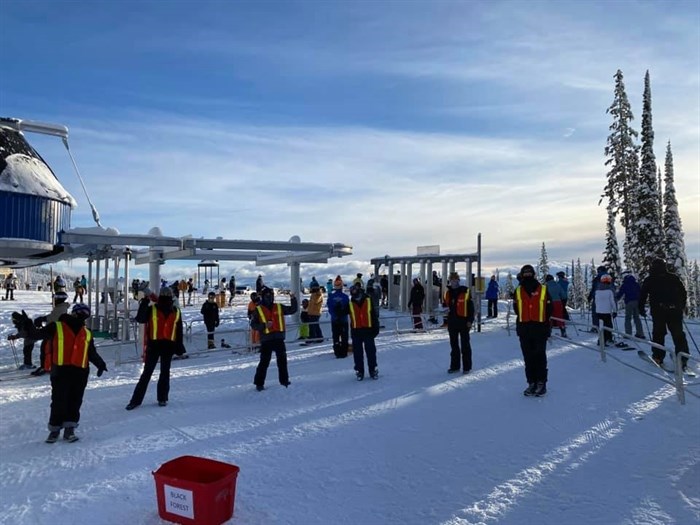 Big White Ski Resort staff standing six feet apart.