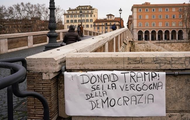 A sign is exposed on Sisto bridge in Rome reading in Italian: “Donald Tramp you are the shame of democracy.”, Thursday, Jan. 7, 2021. Italians on the street in Rome Thursday expressed shock and horror at the events on Capitol Hill in Washington Wednesday evening and cast blame on lame duck President Donald Trump.