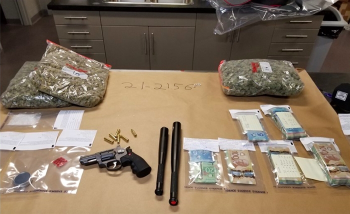 Kelowna Rcmp Seize 20k In Cash Along With Weapons Drugs During Raid