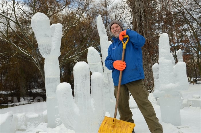 Ice sculptor Brian Rouble stands among the sculpture he worked on.