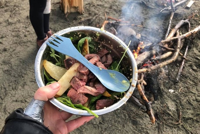Campfire-grilled steak on a peach, spinach salad. Meal prep kits even work in the backcountry, as proven by this industrious camper.