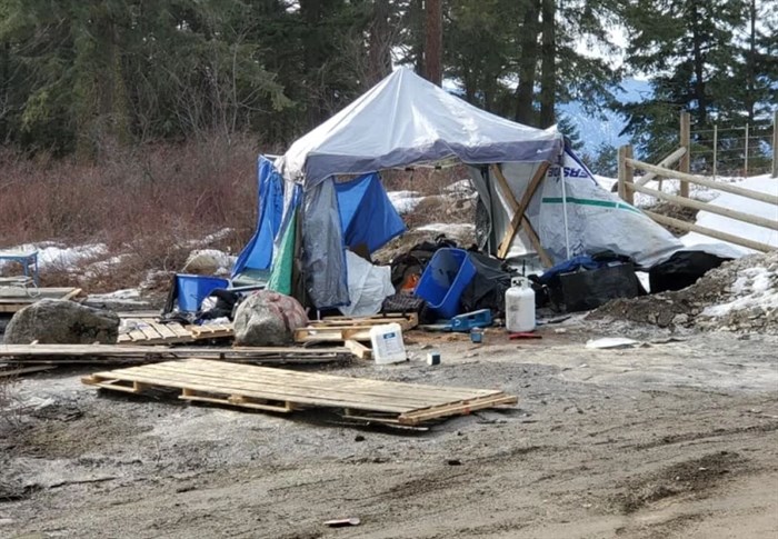 A tent is seen among a pile of trash left behind by campers beside Beaver Lake Road