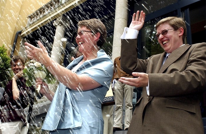 Belgians Marion Huibrechts, right, and Christel Verswyvelen leave the town hall of Kappelen, north Belgium, Friday, June 6, 2003. The two women became the first gay couple to marry in Belgium on Friday under laws passed earlier this year. Huibrechts and Verswyvelen celebrated 16 years of partnership with official vows at a civil ceremony.