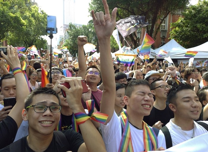 People cheer outside the Legislative Yuan in Taipei, Taiwan on Friday, May 17, 2019, after the passage of a law allowing same-sex marriage - a first for Asia.