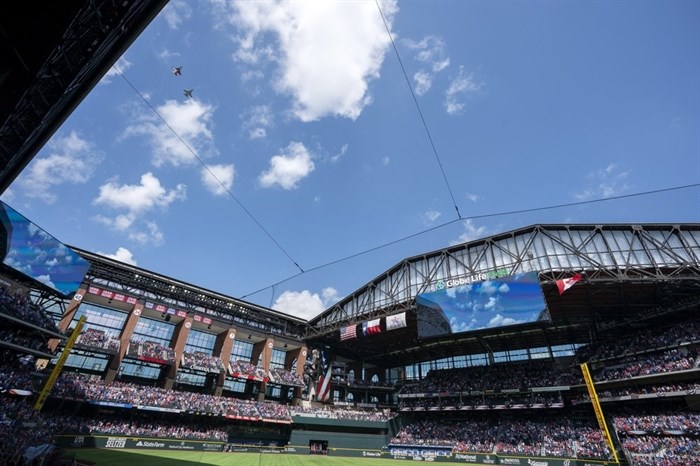 Two F-16 jets fly over Globe Life Field before a baseball game between the Texas Rangers and the Toronto Blue Jays Monday, April 5, 2021, in Arlington, Texas. The Texas Rangers are set to have the closest thing to a full stadium in pro sports since the coronavirus shut down more than a year ago.