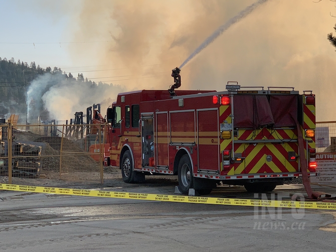 Fire crews battle a blaze at an apartment building under construction near Glenmore and Union Roads in Kelowna, Tuesday, April 6, 2021.