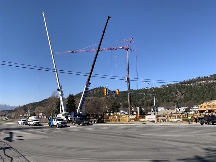 Crews are on site trying to bring down a 40-metre tall crane damaged in a fire at an under construction condo complex in Kelowna last week.