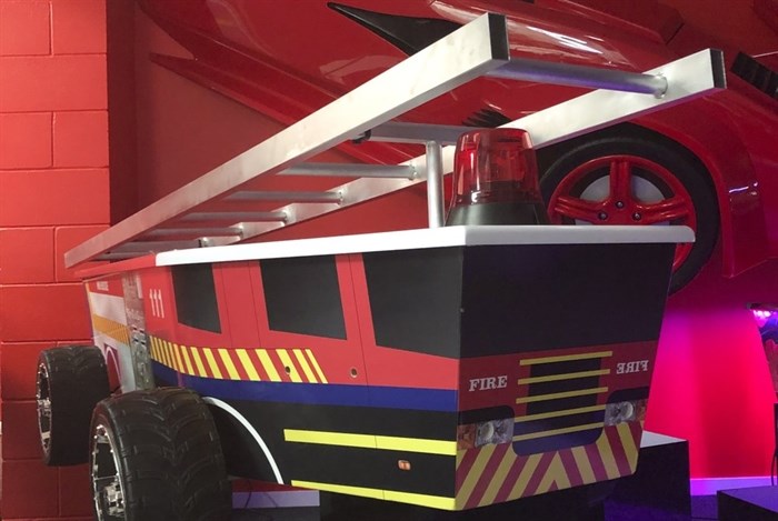 This photo provided by Ross Hall, shows a casket in the design of a fire engine in Auckland, New Zealand Feb. 5, 2019. 