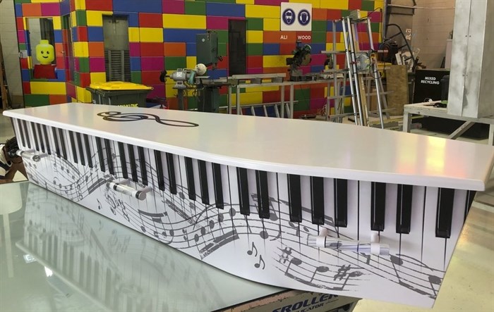 This photo provided by Ross Hall, shows a piano keyboard designed casket in Auckland, New Zealand May 7, 2019.