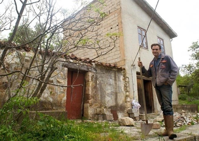 Cain Burdeau stands in front of former barns in Castelbuono, Sicily, on April 13, 2021, that he plans to convert into a family home.