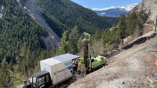 Drilling on a side slope on the Trans-Canada Highway reconstruction project.