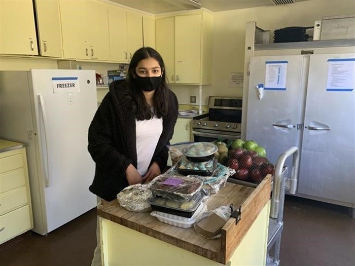 Vedika Jawa poses with freshly baked desserts inside South Hayward Parish in Fremont, Calif., on Feb. 1, 2021. Jawa, a high school junior, distributes sweets to 15 shelters through a non-profit she started when she was 13.