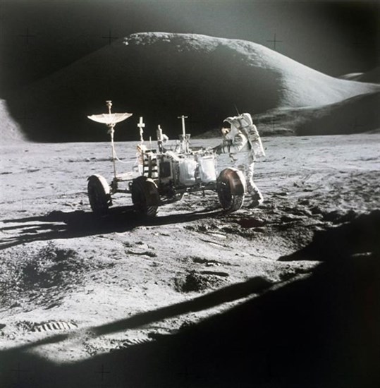 FILE - In this 1971 photo made available by NASA, astronaut James Irwin stands next to a rover on the surface of the moon. On Wednesday, May 26, 2021, Lockheed Martin and General Motors announced that they would combine their technological and manufacturing expertise to build the electric vehicles for NASA’s Artemis program, named after the twin sister of Apollo in Greek mythology.