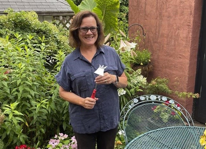 Elizabeth Licata, moderator of the Facebook group, WNY Gardeners, poses for a photograph on July 8, 2021 in Buffalo, N.Y. Moderating a Facebook gardening group is not without challenges. Facebook's algorithms sometimes flag the word " hoe" as "violating community standards," apparently referring to a different word, one without an "e" at the end that is nonetheless often misspelled as the garden tool. Licata said it has been futile trying to reach Facebook to correct the mistake.