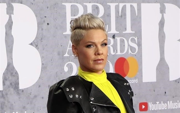 FILE - In Wednesday, Feb. 20, 2019 file photo, singer Pink poses for photographers upon arrival at the Brit Awards in London. U.S. pop singer Pink has offered to pay a fine given to the Norwegian female beach handball team for wearing shorts instead of the required bikini bottoms. Pink said she was “very proud” of the team for protesting against the rule that prevented them from wearing shorts like their male counterparts. At the European Beach Handball Championships in Bulgaria last week, Norway’s female team was fined 1,500 euros ($1,770) for what the European federation called improper clothing and “a breach of clothing regulations.” 