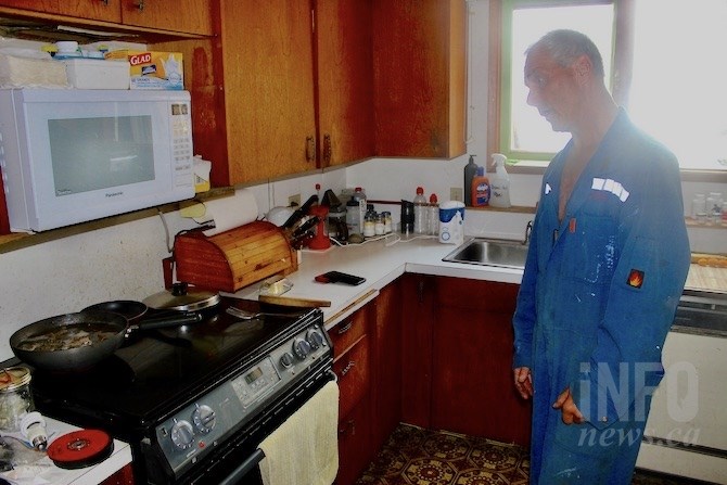 The kitchen, where he lives, is free of building supplies.
