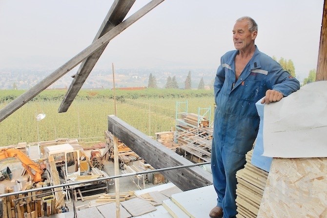 Janusz Grelecki stands on the deck of his house that the City of Kelowna is renewing demolition action against.