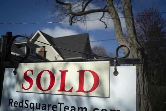 The Canadian Real Estate Association says home sales continued to cool in July as they fell on a month-over-month basis for a fourth-consecutive month. A real estate sold sign is shown in a Toronto west end neighbourhood May 16, 2020.