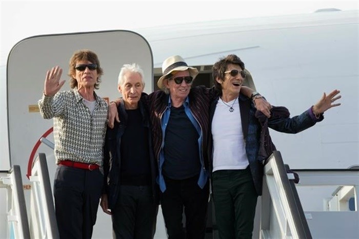 FILE - Members of The Rolling Stones, from left, Mick Jagger, Charlie Watts, Keith Richards and Ron Wood pose for photos from their plan at Jose Marti international airport in Havana, Cuba on March 24, 2016. Watts' publicist, Bernard Doherty, said Watts passed away peacefully in a London hospital surrounded by his family on Tuesday, Aug. 24, 2021. He was 80. 