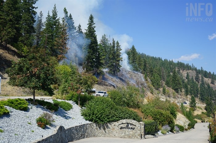 A new wildfire has been discovered on the other side of these homes near Westside Road
