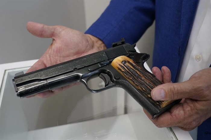 Brian Witherell displays a Colt .45-caliber pistol that once belonged to mob boss Al Capone, at Witherell's Auction House in Sacramento, Calif., Wednesday, Aug. 25, 2021. The pistol is among the 174 family heirlooms that will be up for sale at an Oct. 8 auction titled 