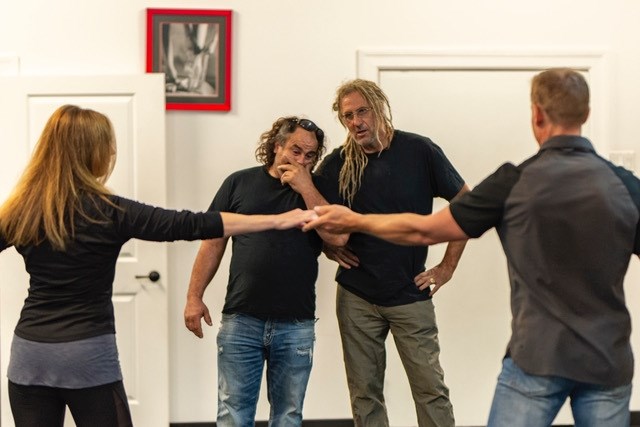 Avery Shoaf (left) and Mike Hall watch as City  Dance owners Heather Stranks and Jens Goerner demonstrate a dance move.