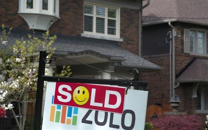 A sold sign is shown in front of west-end home in Toronto, Sunday, May 14, 2017. As the pandemic gives more people reason to move to smaller communities, insurance experts say homebuyers should be aware of higher home insurance premiums outside of larger cities.