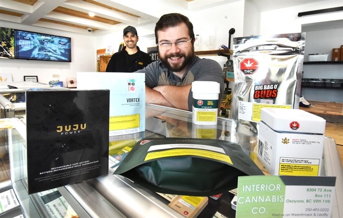 Interior Cannabis Co. employee Olivier Mainville with some of the many products sold at the Osoyoos business. Matt is in the background.