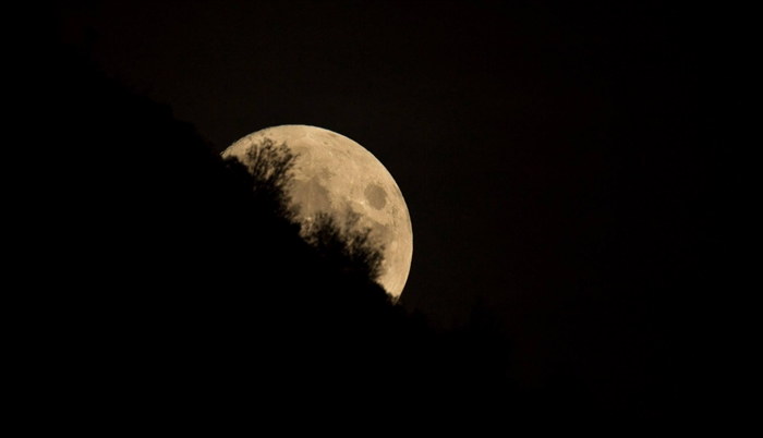 The hunter's moon playing Peak-a-boo.