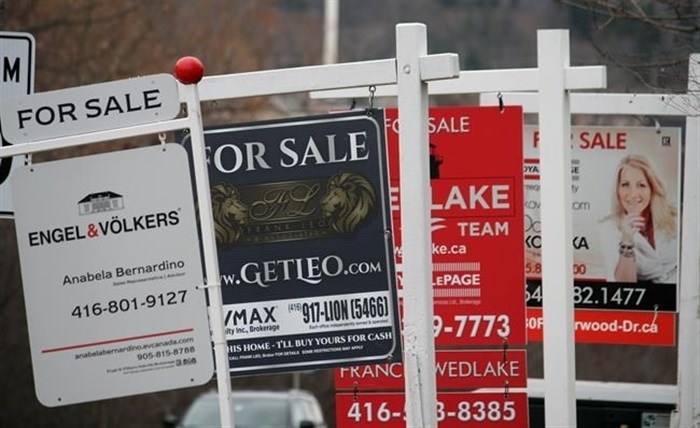 Real estate for sale signs are shown in Oakville, Ont. on Saturday, Dec.1, 2018.