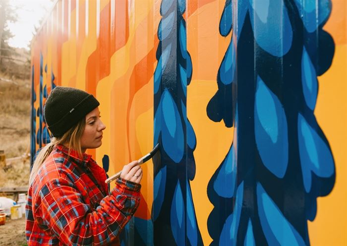 Artist transforms sea can into bright new mural depicting Sun