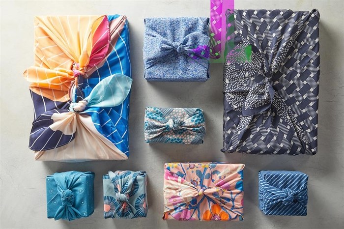 This image provided by Better Homes & Gardens shows fabric-wrapped gifts.