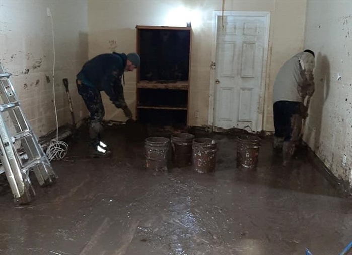 Endeavor to be Better program workers clean up mud in flooded Merritt home.