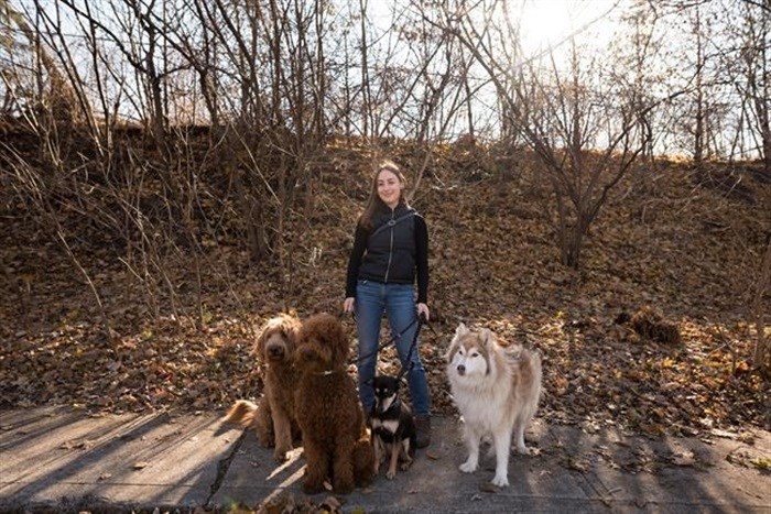 Maddy Hejak, owner of Dog Logic Toronto, poses for a photograph while dog walking for clients in Toronto, on Monday, December 13, 2021.