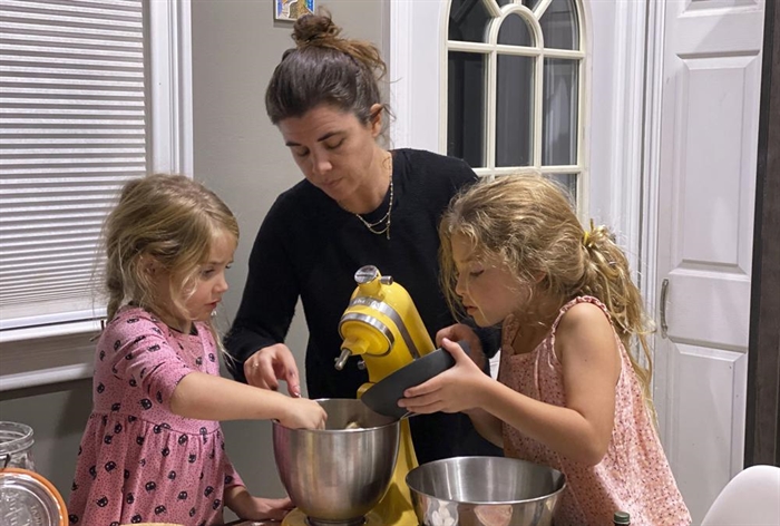Danielle McWilliams cooks with her daughters Reese, 7, right, and Remi, 4, at their New Jersey home. Along with the usual cupcakes, crispy treats and from-scratch cookies, they make tarallis, an Italian family traditional treat that’s a cross between a breadstick, bagel and pretzel.