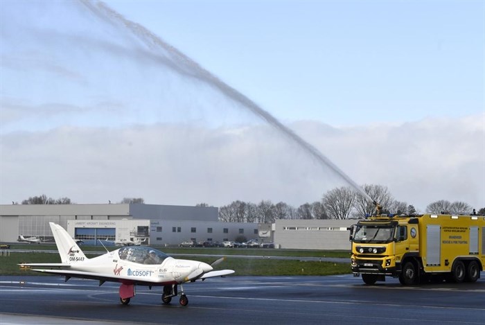 A firetruck sprays the plane of Belgium-British teenage pilot Zara Rutherford as she lands her Shark ultralight plane at the Kortrijk airport in Kortrijk, Belgium, Thursday, Jan. 20, 2022.