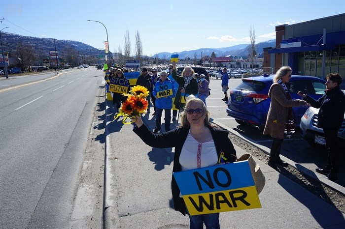 Holding the flowers is Sherry Mitchell who co-organized the pro-Ukraine rallies in Penticton.