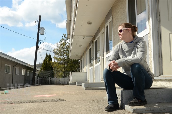 Bethany Merry sits outside her one-bedroom Vernon motel room.