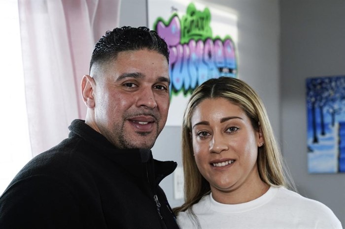 Eladio and Melissa Guzman pose for photographs, Monday, April 4, 2022, in Hicksville, N.Y. The couple, who endured the war on drugs, including jail time, are now eager to open a recreational marijuana dispensary in New York.