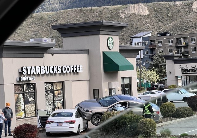 A car is seen propped on the front of another in a Kamloops Starbucks drive-thru.
