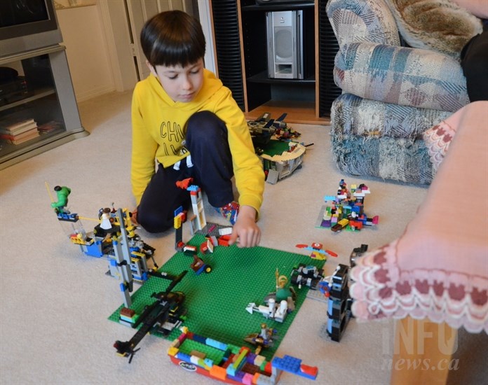 Mykyta, 6, plays with his lego.