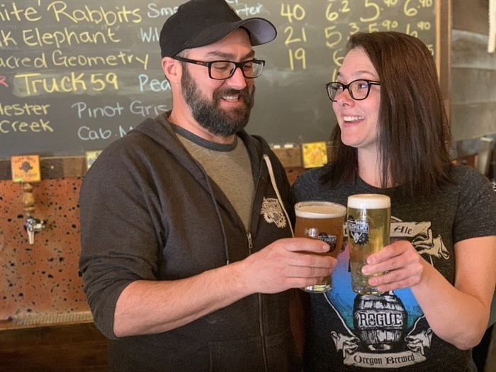 Co-owners and husband and wife duo Al and Shantel Renner cheer at Alchemy Brewing.