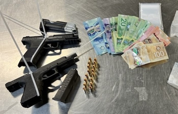 Weapons, and cash seized by Kelowna RCMP, May 16, 2022. 