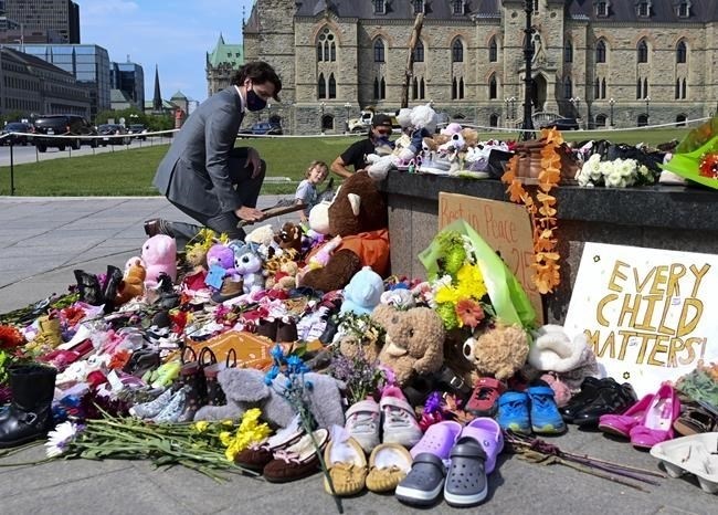 Prime Minister Justin Trudeau visits a memorial at the Centennial Flame on Parliament Hill in Ottawa on Tuesday, June 1, 2021, in recognition of discovery of unmarked graves at the site of a former residential school in Kamloops, B.C.