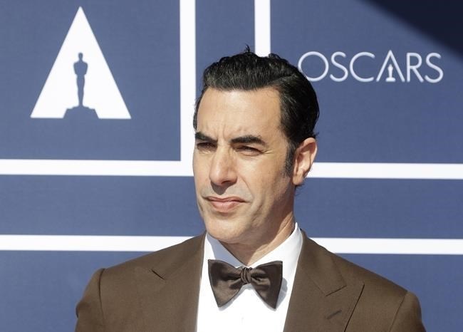 FILE - In this April 26, 2021 file photo, Sacha Baron Cohen arrives to attend a screening of the Oscars in Sydney, Australia. Cohen has dropped his lawsuit against a Massachusetts cannabis dispensary that used an image of his character Borat on a billboard without his permission.