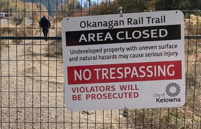 FILE PHOTO - A fence on the Kelowna side of the Okanagan Rail Trail has a sign warning users the section heading to Lake Country is closed.