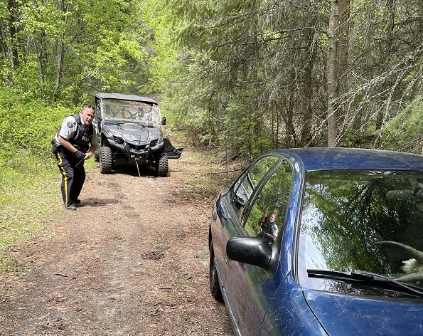 A Penticton RCMP officer used his quad to rescue a stranded car from a creek on the Kettle Valley Rail trail, Saturday, May 28, 2022.