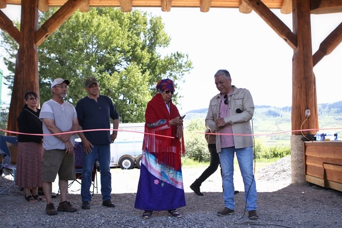 Elder Pauline Gregoire-Archachan cuts the ribbon during the Okanagan Indian Band’s grand reopening of its Cultural Arbor on May 28.