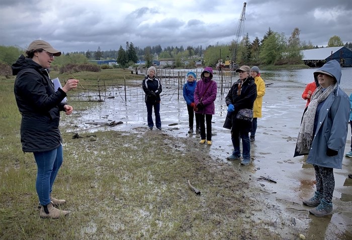 Greenways executive director Cynthia Bendickson explains the importance of grasses and the destructive tendencies of geese to visitors on the shore of the Baikie Island Reserve.